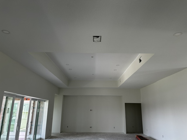 Completed ceiling and drywall finish in an open room