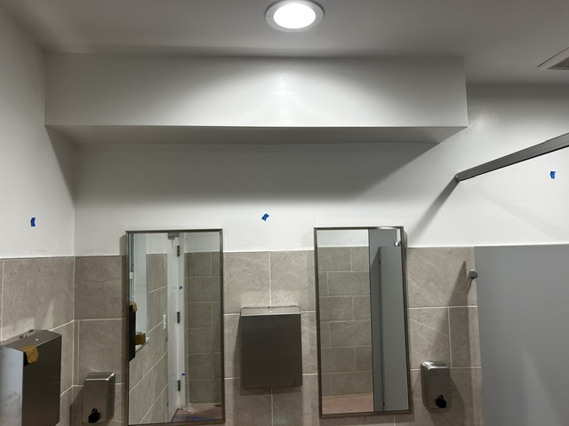Finished drywall and ceiling work in a commercial restroom