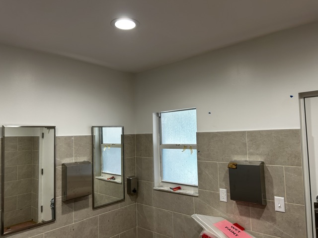 Completed restroom wall and ceiling finish work